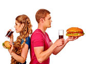 Muž a žena jíst velké sendvič s colou. Izolovaný.
