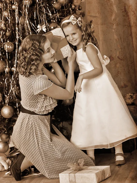 Child with mother receiving gifts — Stock Photo, Image