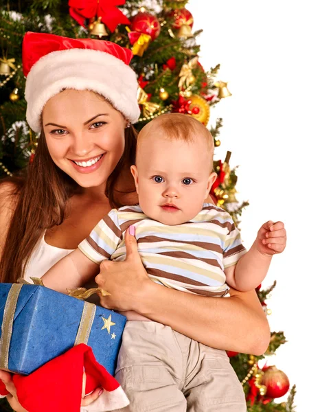 Mom holding baby under Christmas tree — Stock Photo, Image