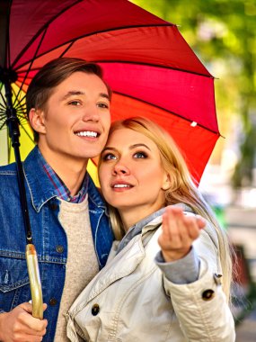 Genç çift şemsiyesi altında