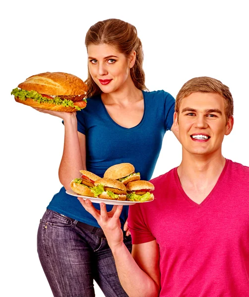 Erkek ve kadın cola ile büyük sandviç yeme. İzole. — Stok fotoğraf