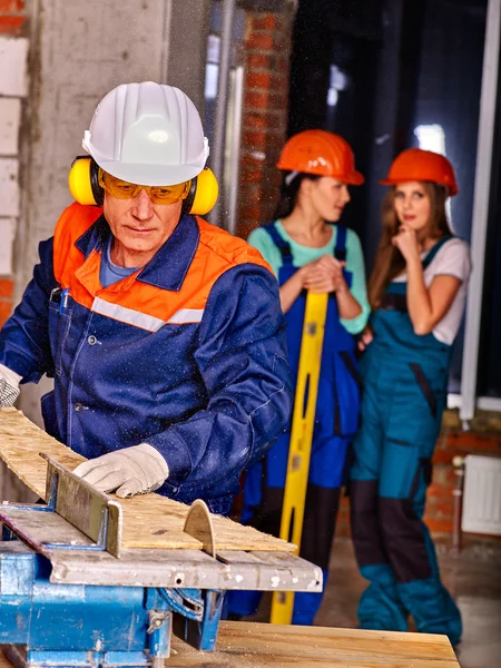 Group people  builder with circular saw . — Stock Photo, Image