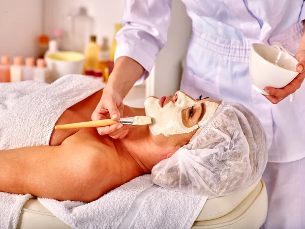 Woman middle-aged take face massage in spa salon. — Stock Photo, Image