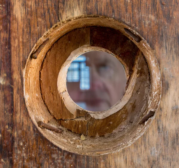 Ghostly face and eye looking through peephole — Stock Photo, Image