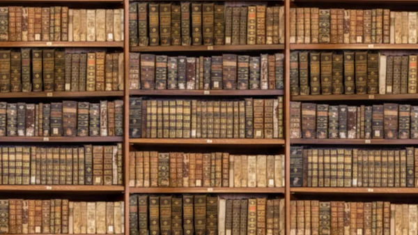 Defocused shelves of old antique books for background in video conference sized to 16 by 9 — Stock Photo, Image