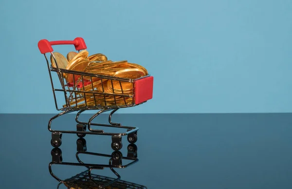 Sale mockup or background with shopping cart filled with gold coins — Stock Photo, Image