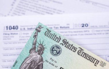 US Treasury check for stimulus in 2020 against a USA Form 1040 clipart