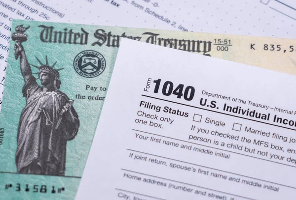 US Treasury check for stimulus in 2020 against a USA Form 1040 — Fotografia de Stock