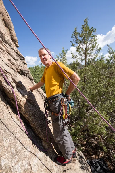 Senior man starting rock climb in Colorado — Stock Photo, Image