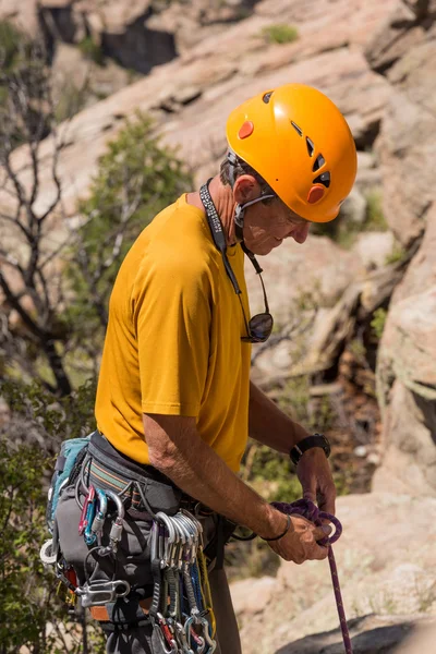 Senior man starting rock climb in Colorado — Stock Photo, Image