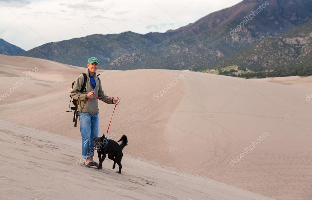 Man with dog on Great Sand Dunes NP 