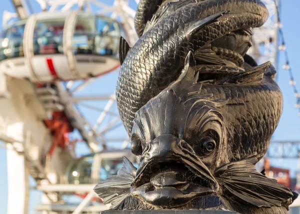 Schnitzerei von Fischen am Flussufer mit dem Londonauge — Stockfoto