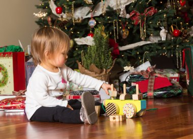 Noel hediyeler ile oynayan genç beyaz bebek kız