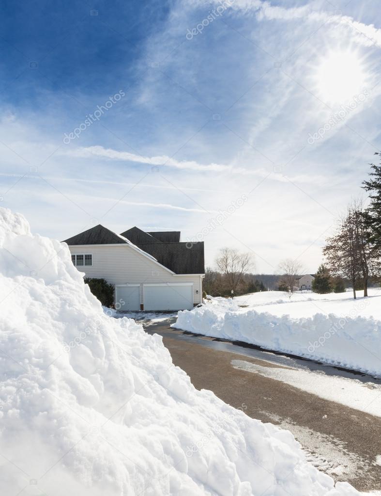 Deep drifts by side of driveway to modern home
