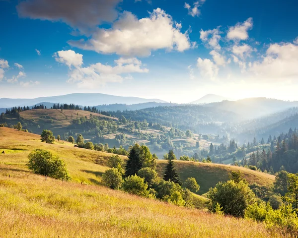 Sunny hills under morning cloudy sky. — Stock Photo, Image