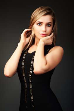A pretty young woman in fashion spring coat brown.
