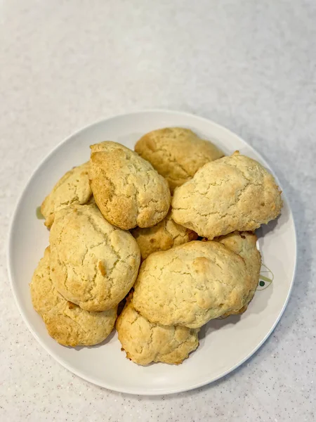 Scone is a baked good, usually made of either wheat or oatmeal with baking powder as a leavening agent, and baked on sheet pans. A scone is often slightly sweetened and occasionally glazed with egg wash