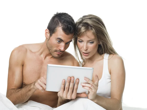 Attractive couple watching things in a tablet — Stock Photo, Image