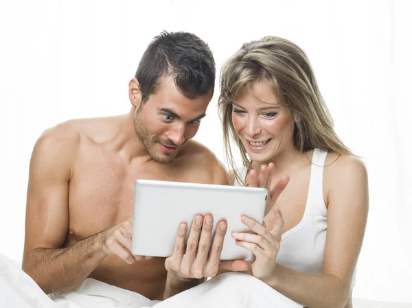 Attractive couple watching things in a tablet — Stock Photo, Image