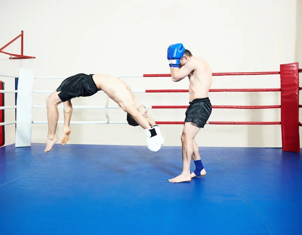 Muay thai sportsman fighting at boxing ring — Stock Photo, Image