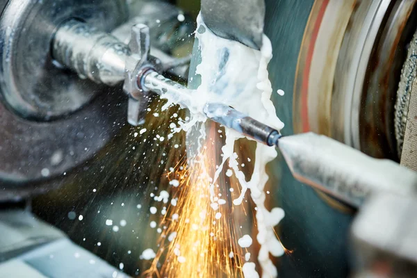 Metalworking industry. finishing metal surface on grinder machine Royalty Free Stock Images