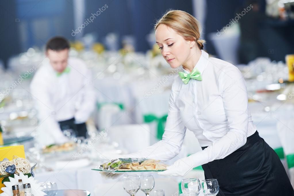 Restaurant services. Female waitress serving table Stock Photo by  ©kalinovsky 105938072