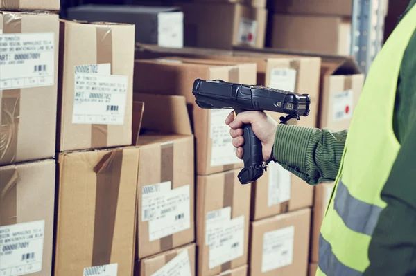 Warehouse Management System. Worker with barcode scanner