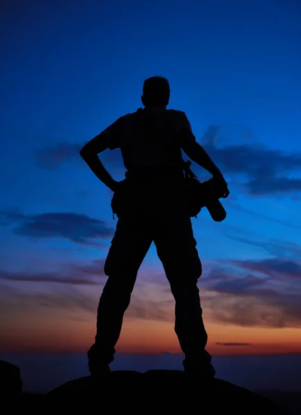 Professional photographer silhouette at sunset or sunrise — Stock Photo, Image