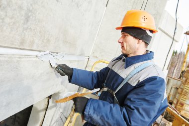 Duvar macun mastik ile binanın ortak mühürleme cephe sıvacı