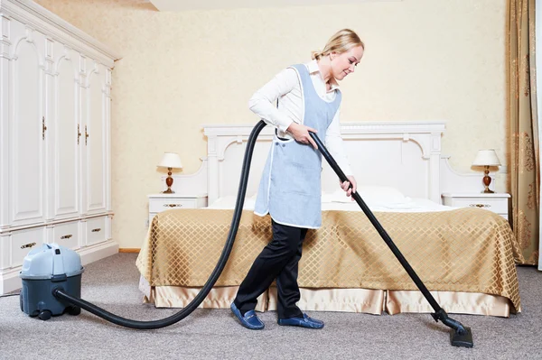 Hotel service. female housekeeping worker with vacuum cleaner — Stock Photo, Image