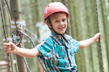 Macera ve teleferik etkinlik ormandaki tırmanma mutlu çocuk