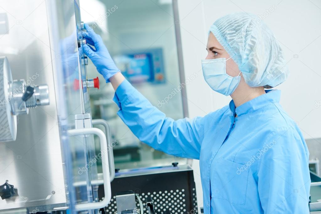 Pharmaceutics. Pharmaceutical worker operates blister packaging machine