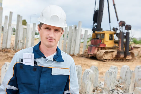 Construction worker foreman in front of pile driver machine — Stok fotoğraf