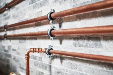 Plumbing service. copper pipeline of a heating system in boiler room clipart