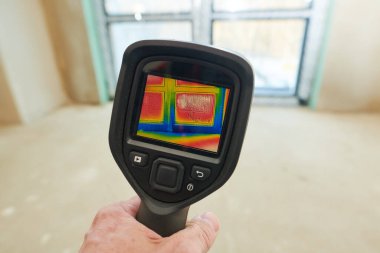 thermal imaging camera inspection of window building. check heat loss clipart