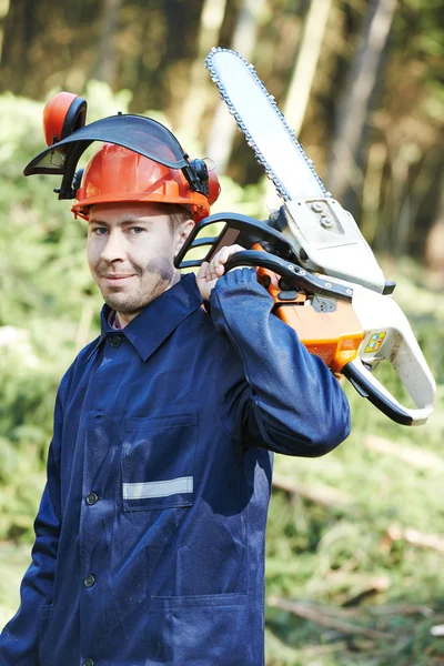 Lumberjack worker with chainsaw in the forest — Stock Photo, Image