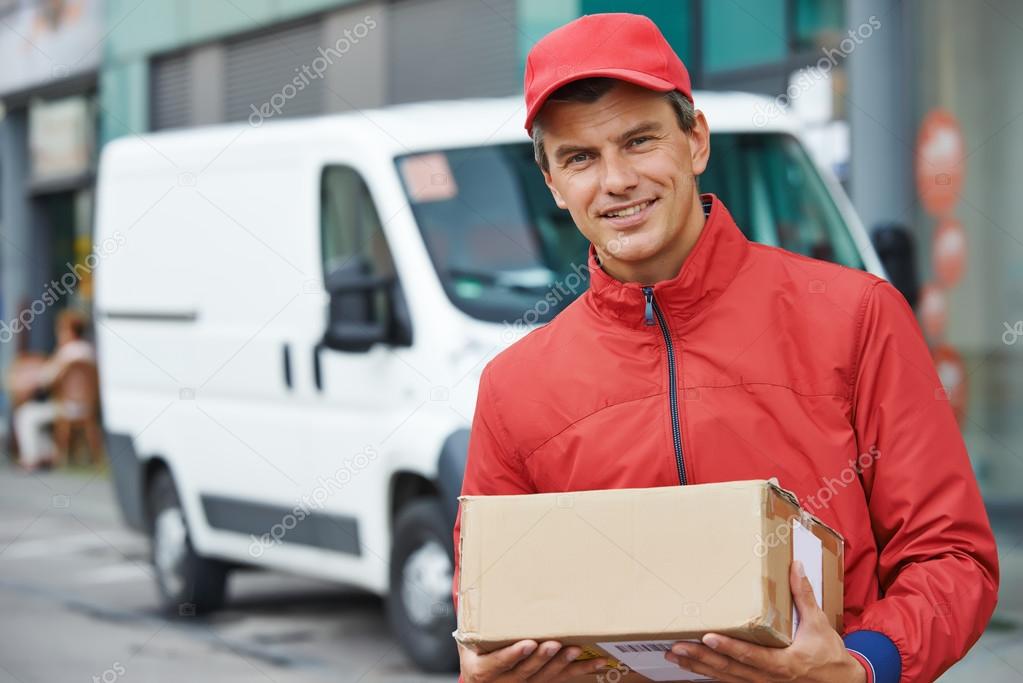 Delivery man with package outdoors — Stock Photo © kalinovsky 52491179