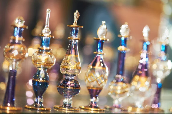 Perfume or oil in decorative glass bottles — Stock Photo, Image