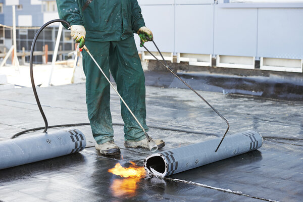 Flat roof covering repair works with roofing felt