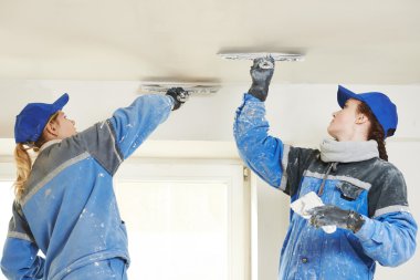 Plastererst at indoor ceiling work clipart