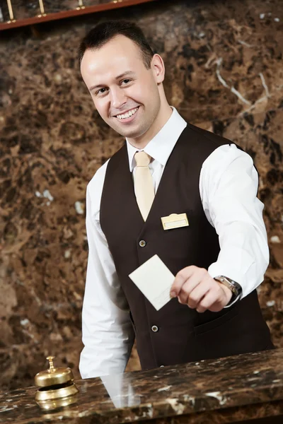 Hotel worker with key card — Stock Photo, Image