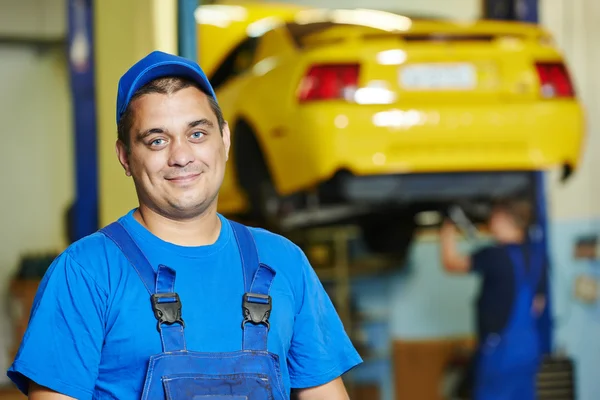 Repairman auto mechanic at work Royalty Free Stock Images