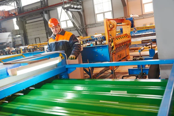 Worker at metal sheet profiling factory — Stock Photo, Image