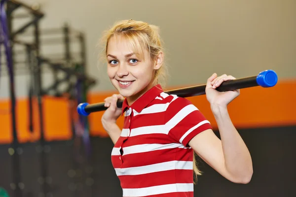 Woman with stick in fitness gym — Stock Photo, Image