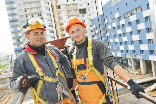 Builders workers at construction site — Stock Photo, Image