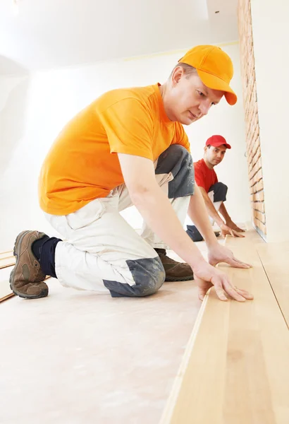 Lavoratori di parquet al lavoro di pavimentazione — Foto Stock