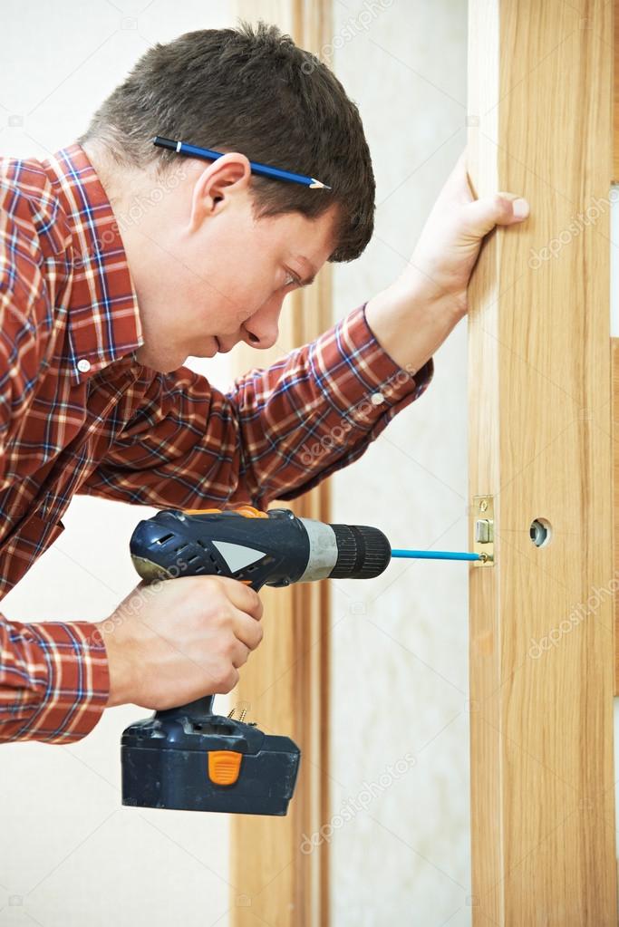 carpenter at door lock installation