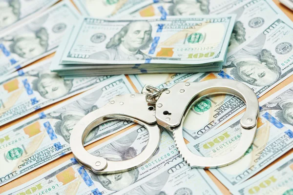 Bribe concept. dollars and handcuffs — Stock Photo, Image