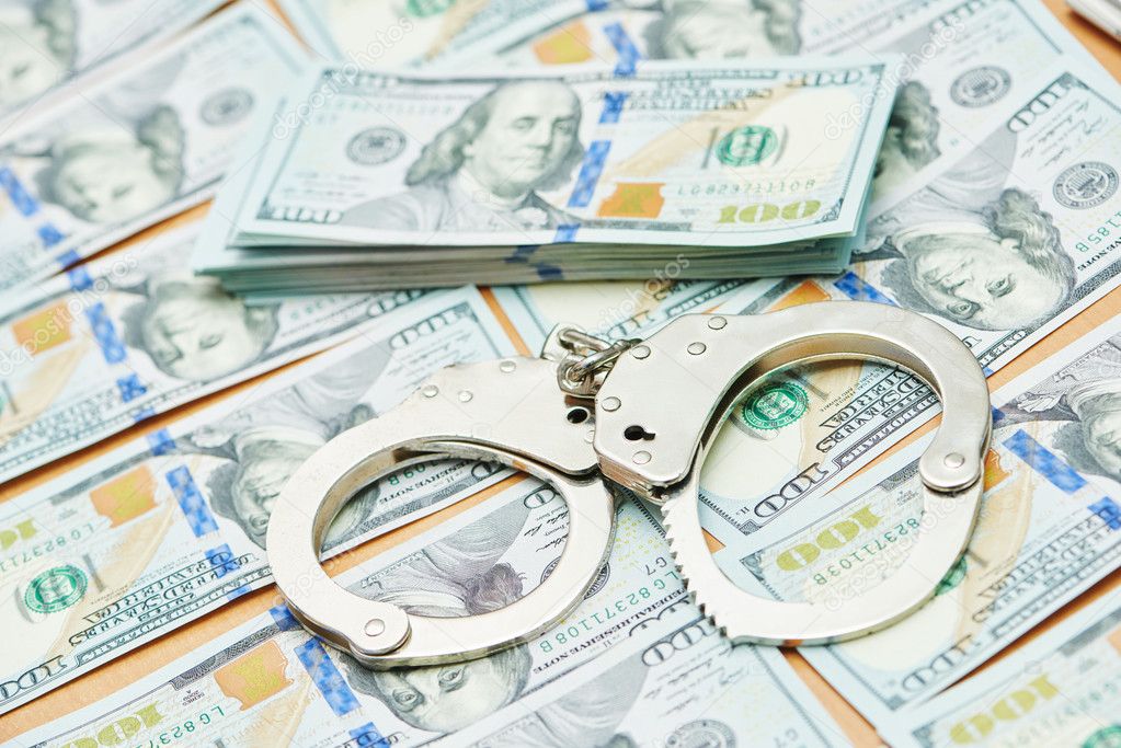 bribe concept. dollars and handcuffs