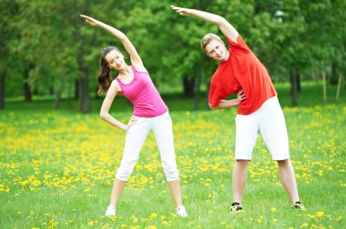 Fitness erkek ve kadın germe egzersizleri yapıyor